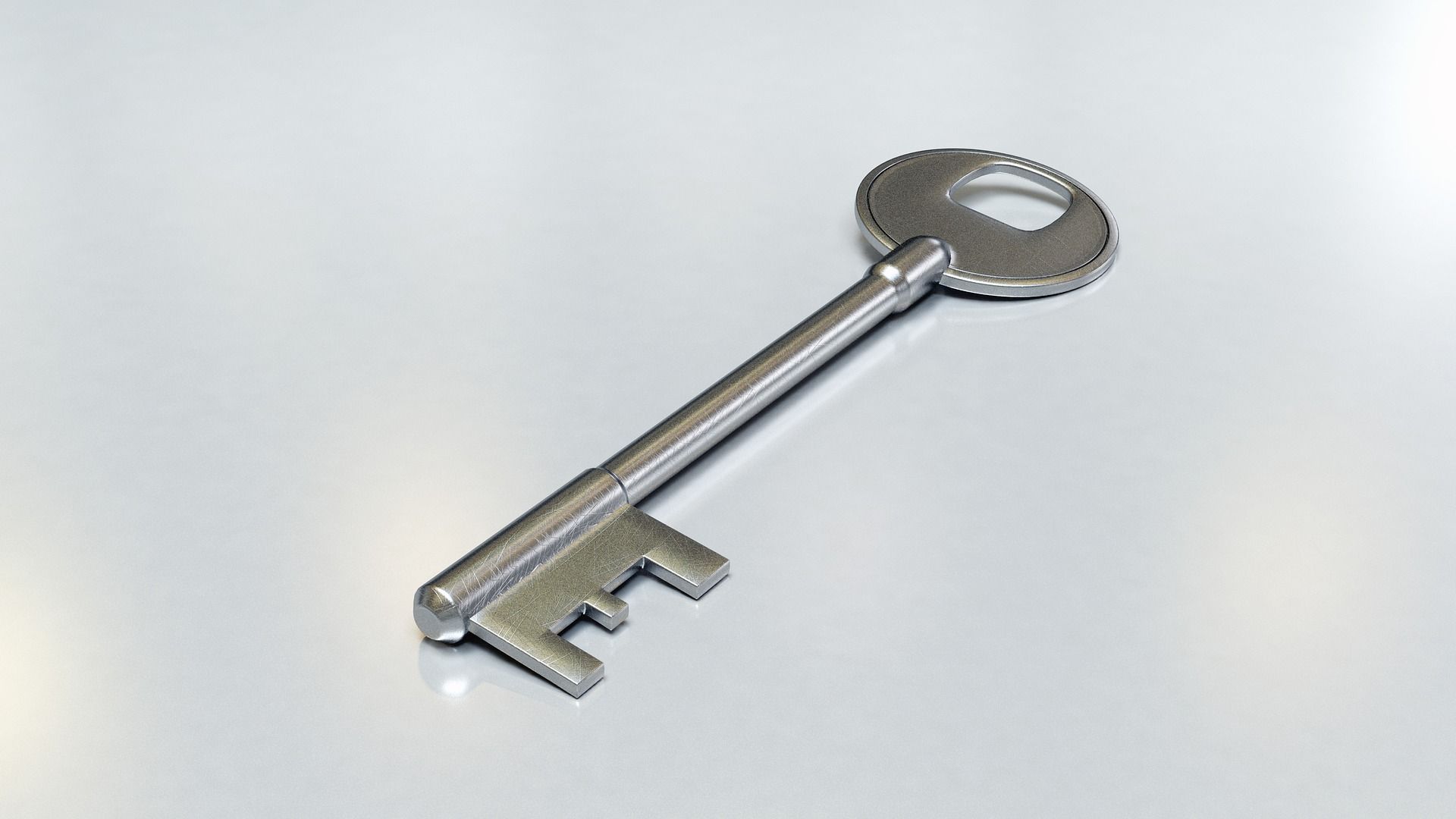 Silver deadlock key on white table