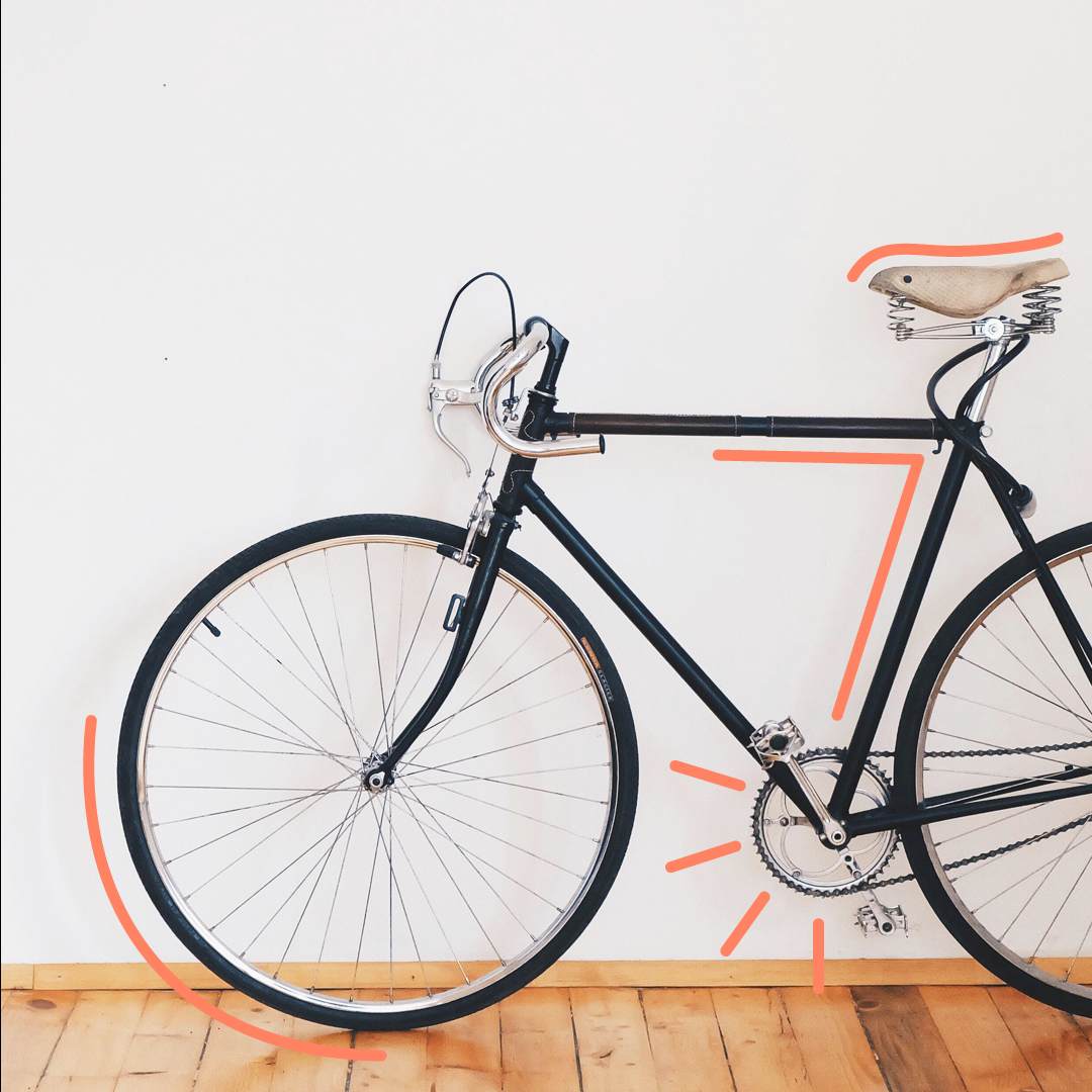 Bike-With-A-Black-Frame-In-Front-Of-A-White-Wall-With-Orange-Outline